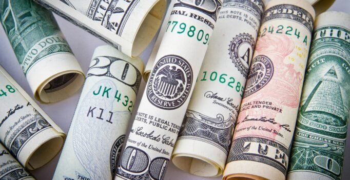 Close-up of rolled US dollar bills symbolizing wealth, financial success, and currency.