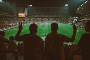 A vibrant football match with fans cheering in an illuminated stadium. Süper Lig En İyi Kulüpler 2026
